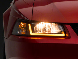 Raxiom 99-04 Ford Mustang Axial Series Headlights w/ Sequential LED Bar- Black Housing (Clear Lens)