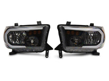 Load image into Gallery viewer, Raxiom 07-13 Toyota Tundra Axial Series Headlights w/ LED Bar- Black Housing (Clear Lens)